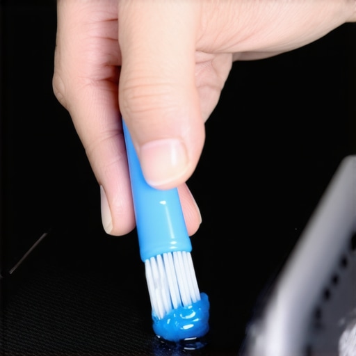 A person using a soft brush and adhesive putty to remove dust from a phone speaker grill.